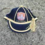 Custom Honours Cap featuring a classic design with embroidered text and logo on the front panel, tailored for recognition and achievement awards. Made with premium fabric and a structured fit, ideal for schools, clubs, and ceremonial events.